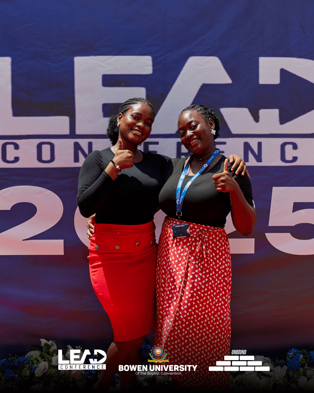 Two delegates posing in front of the LEAD Conference 2025 backdrop